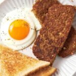 Plate of Sliced Goetta, Sunny Side Egg, and Toast